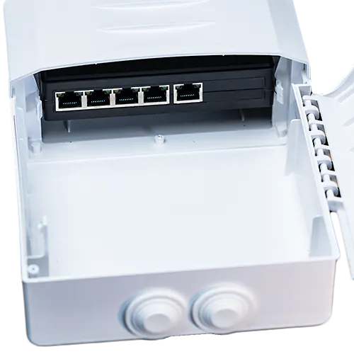 An outdoor plastic enclosure with a five port PoE splitter inside.