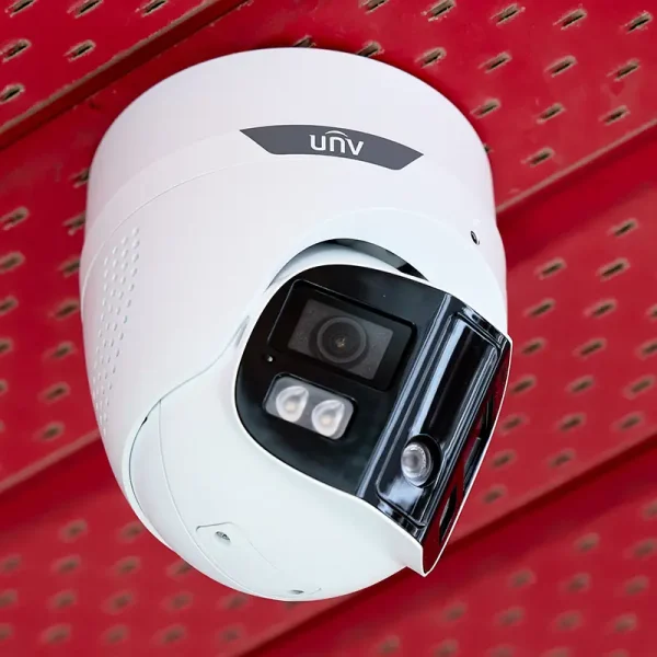 A Uniview 180-degree turret camera installed underneath a red aluminium soffit